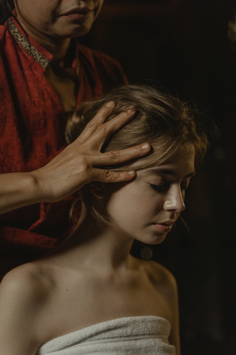 Close-Up Shot of a Person Massaging the Head of the Woman